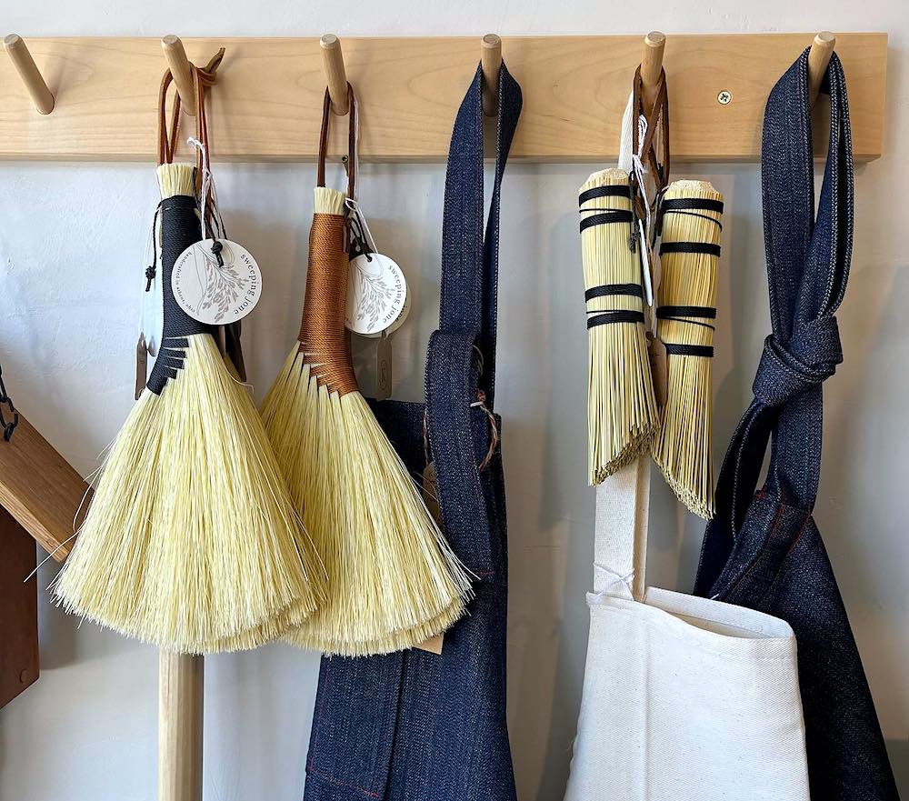 hanf brooms and aprons hanging on the rack