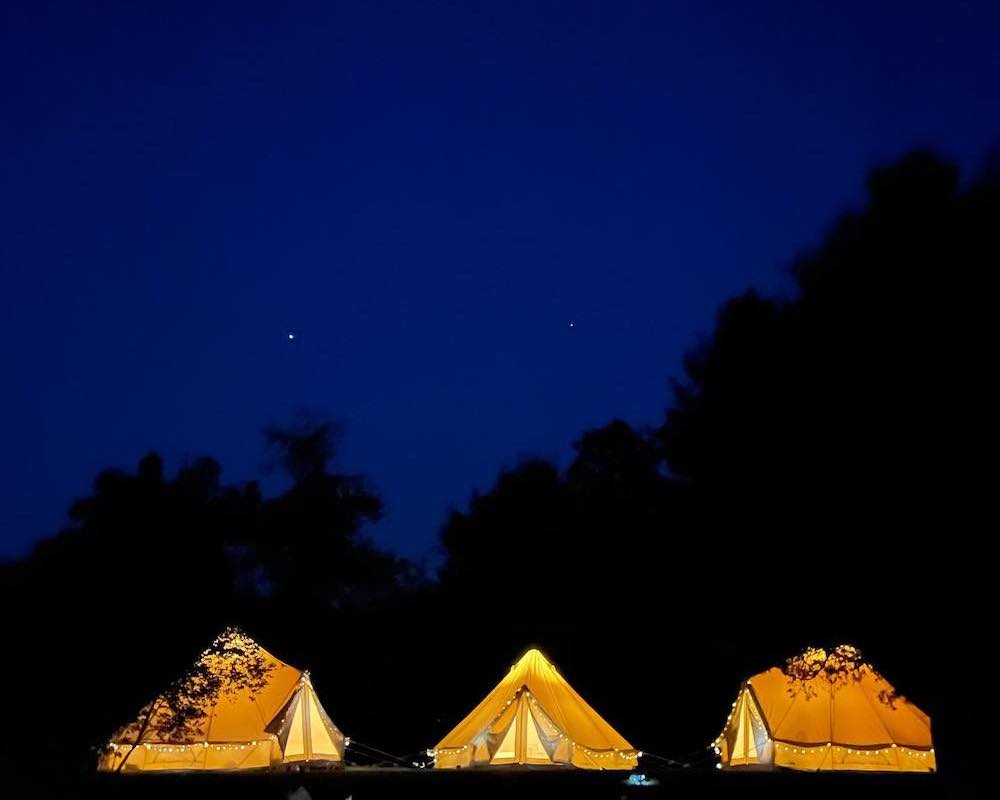 glowing tents in the night