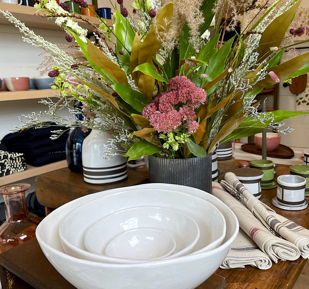 white serving bowls and flowers