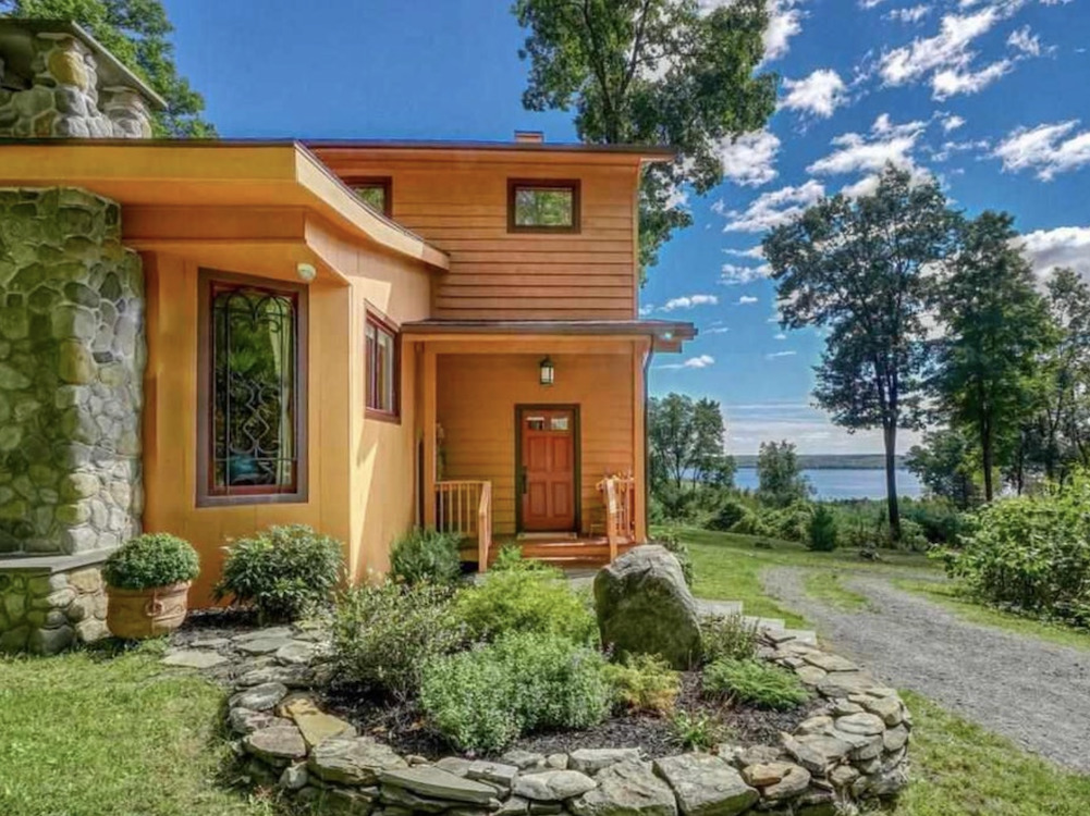 Corner shot when pulling up to the house with little garden and front door at 71 Carly Road in Woodstock, NY listed by Halter Associates Realty.