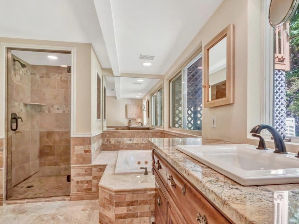 Master bathroom with tub, shower and sink at 71 Carly Road in Woodstock, NY listed by Halter Associates Realty.