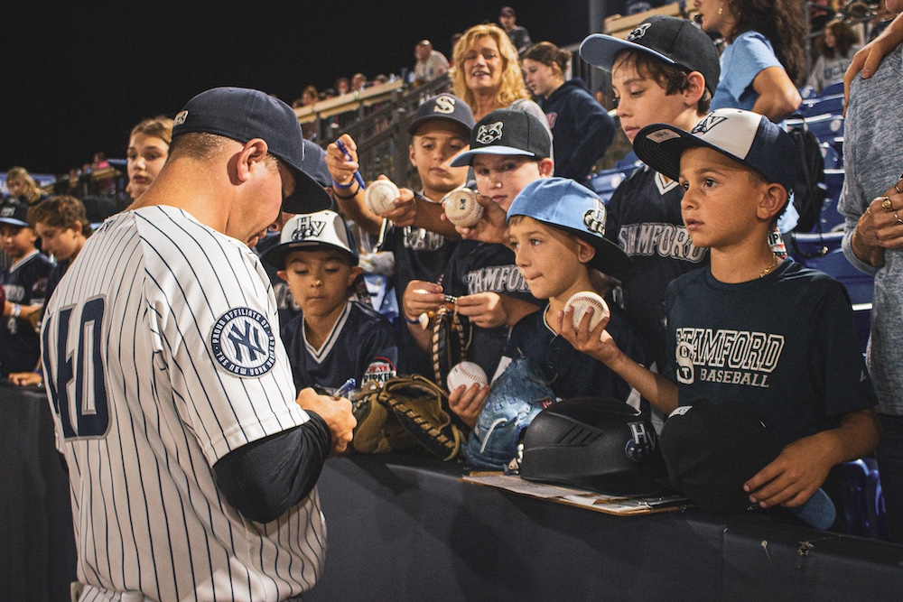 Players signing baseballs for fans at the Hudson Valley Renegades Baseball Team in Wappingers Falls NY