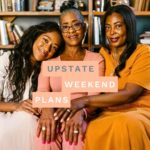 three women of different ages sitting together like two daughters and two mothers with the "Upstate Weekend Plans" text written across the Hudson Valley, NY photo.