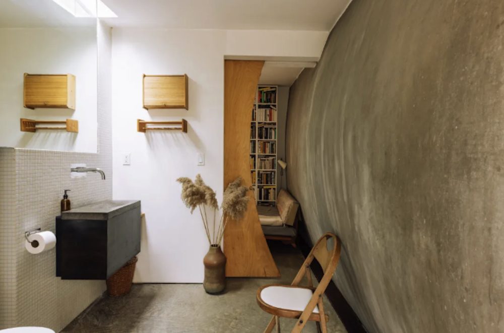 bathroom peek into library at Striking Modernist has Sleek Lines + Graphic Details inMilan, Red Hook, Dutchess County NY