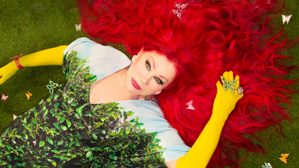 Kate Pierson posing on grass for her new album