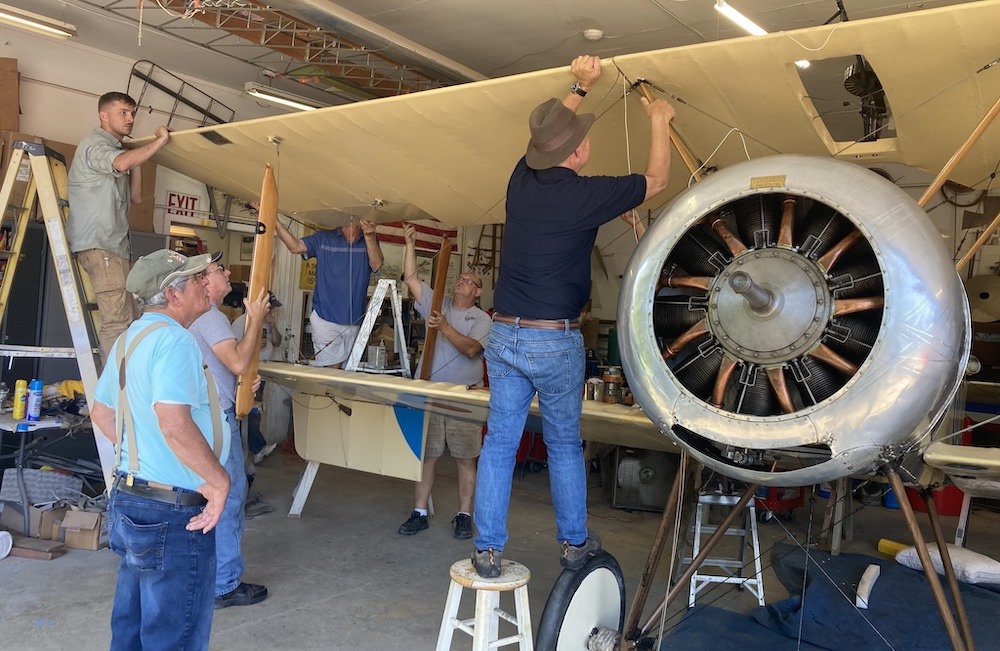 mecahnics in the hangar working on a plane at Old Rhinebeck Aerodrome in Red Hook NY