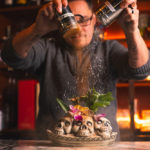 Anton Kinloch garnishing food with cinnamon at Lone Wolf Cocktail Bar in Kingston, NY.
