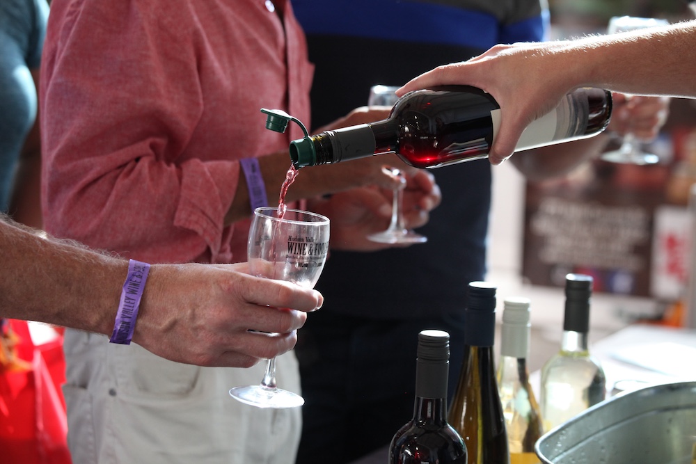 pouring red wine atHudson Valley Wine & Food Festival in Rhinebeck NY