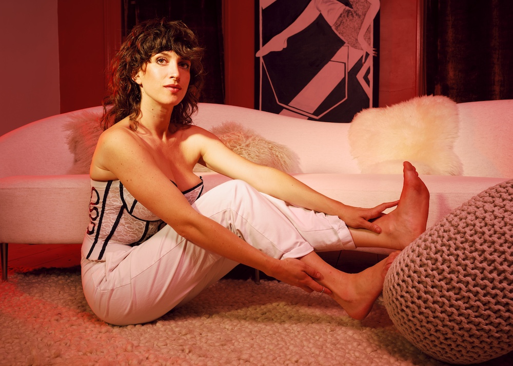 Hudson Valley Singer Songwriter Kendra McKinley in front of couch