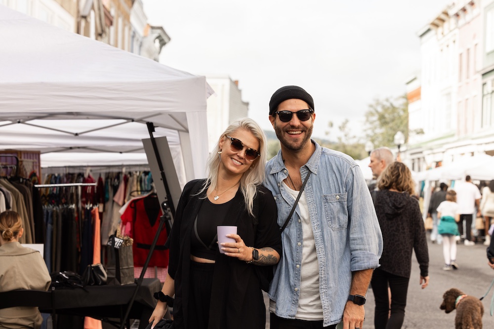 a couple posing on the street at StockadeFaire 2025 in Uptown Kingston NY's Historic Stockade District