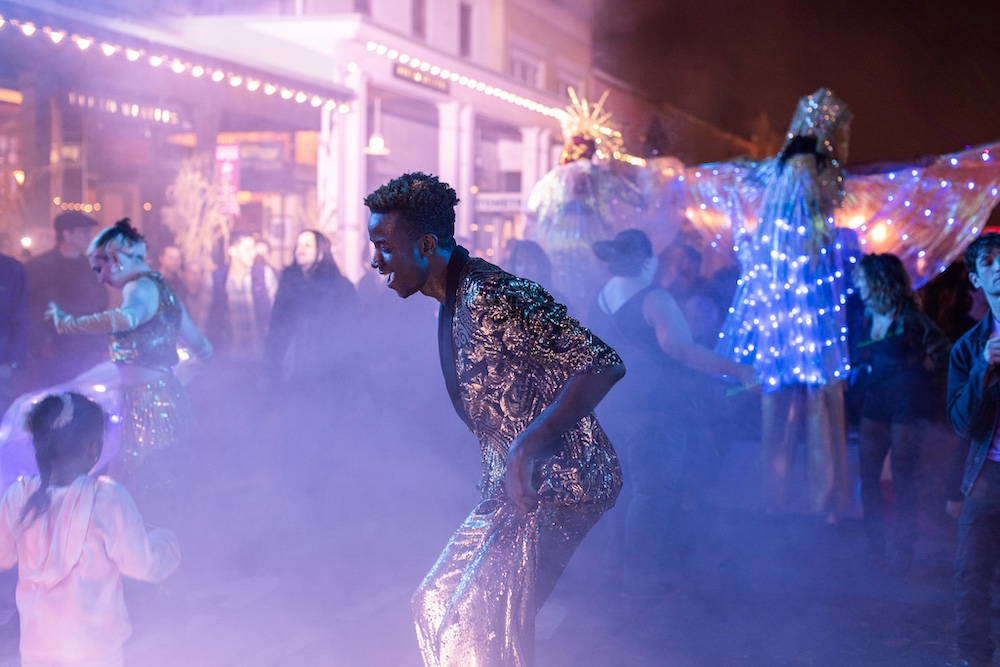 smoke and glitter dancing at night at StockadeFaire 2025 in Uptown Kingston NY's Historic Stockade District