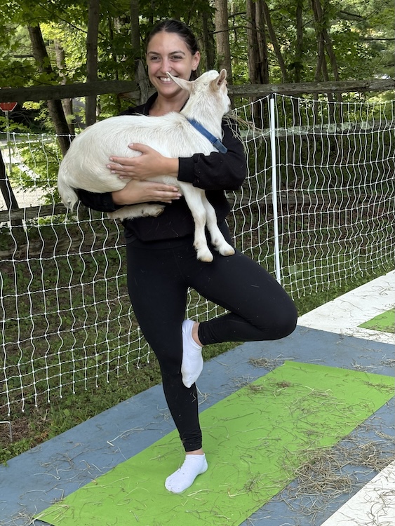 holding baby goat at Woodstock Goat Yoga in Shady, NY.