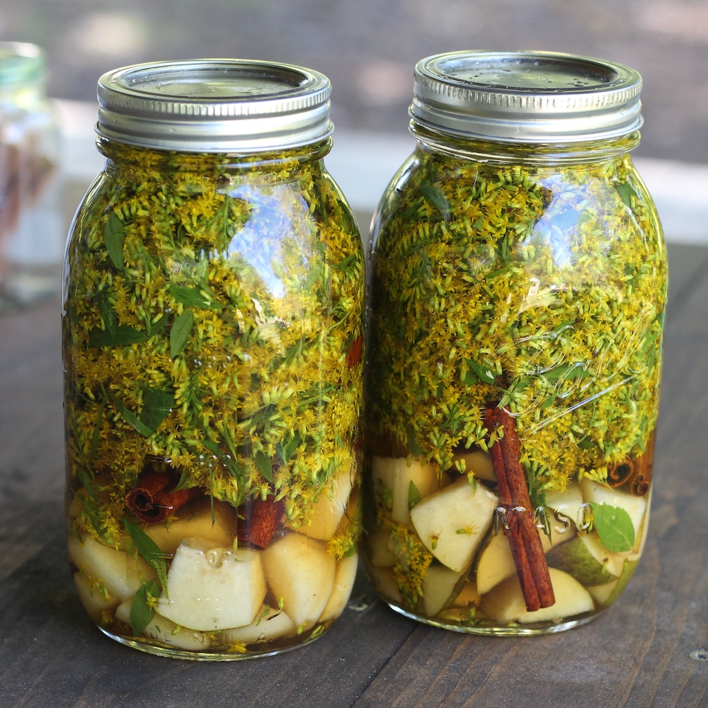 goldenrod, apple, spices brandy in a jar made from Goldenrod in a basket with silk scarf for the Sasha Botanica Infusing Autumn with Goldenrod workshop in high Falls NY