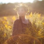 Sasha Botanica walking through a field of Goldenrod in the Hudson Valley NY