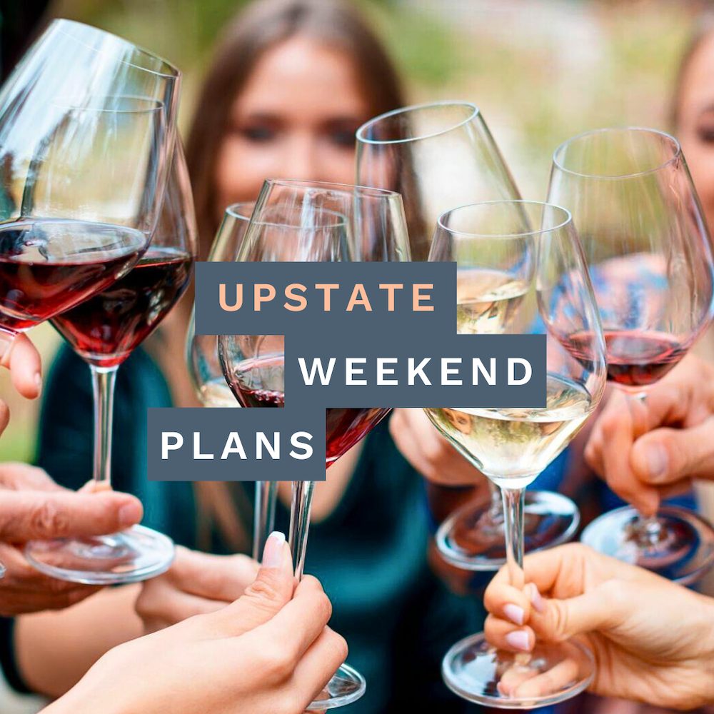 woman lookthing through wine glasses filled with red and white wines with the "Upstate Weekend Plans" text written across the Hudson Valley, NY photo.