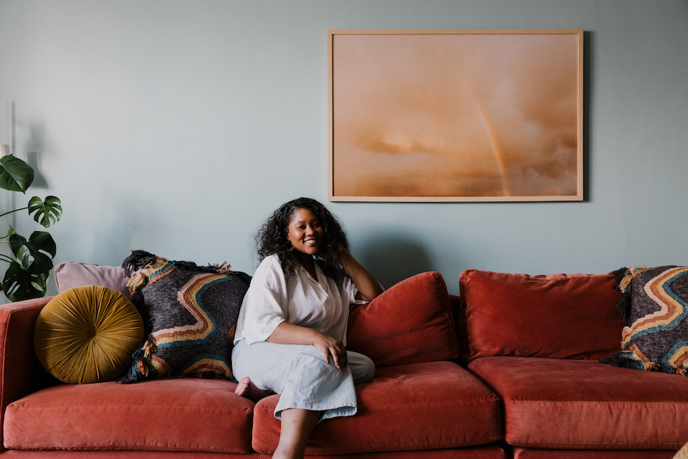 Abigail Horace of Casa Marcelo on orange sofa.