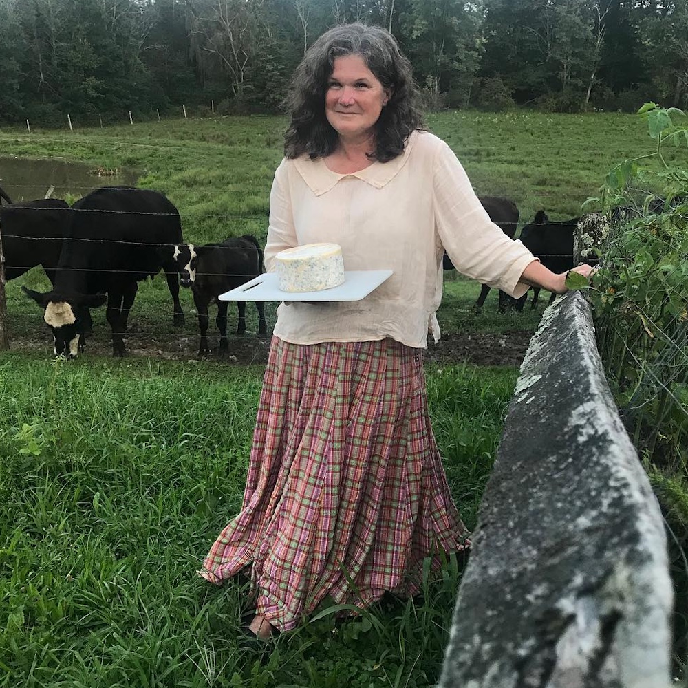 Becky and her homemade cheese with the cows that helped her make it at the Hilltop Farm in Accord NY