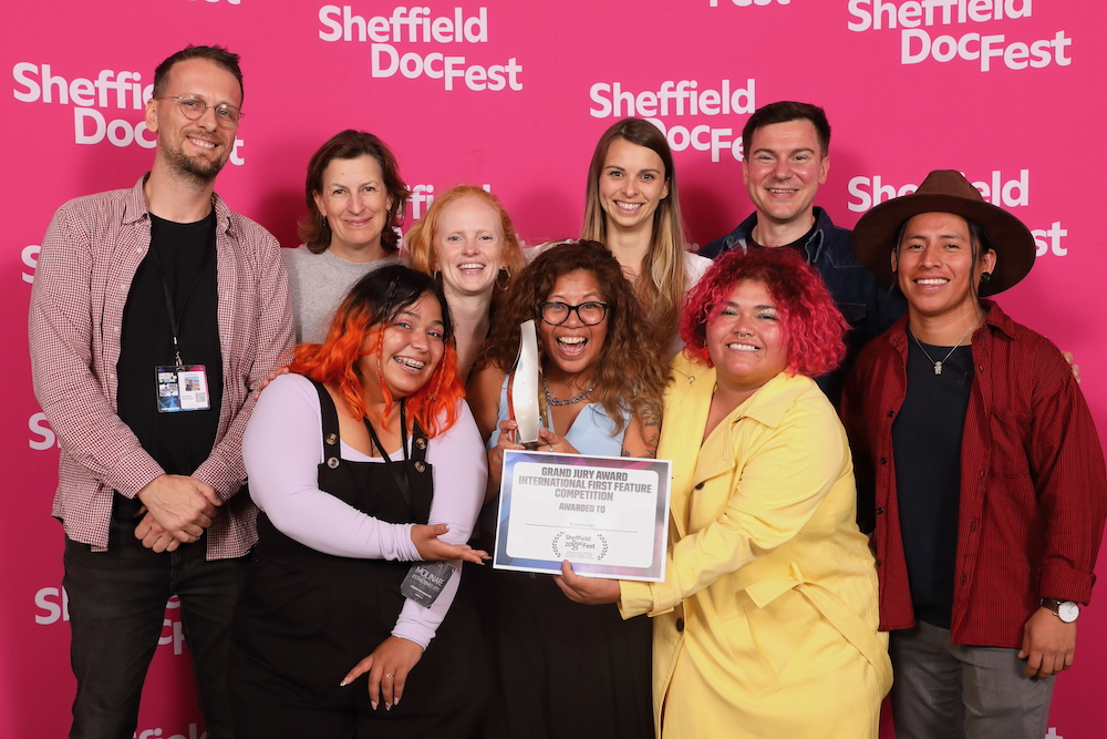 The team celebrates their award at the Sheffield Documentary Festival in 2025.