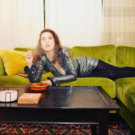 Dj Sheri Barclay smoking on chartreuse couch