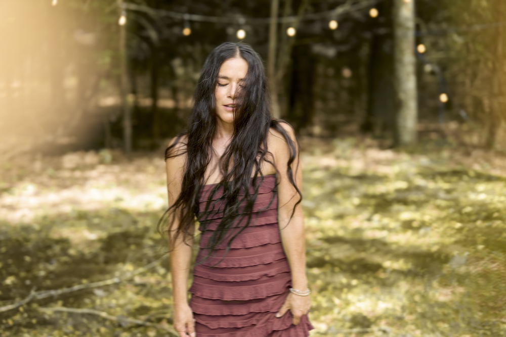 Rachael Yamagata in a brown dress outside