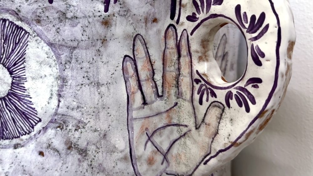 Painted clay vessel with image of hand by sculptor Nicki Green, Kingston, NY.