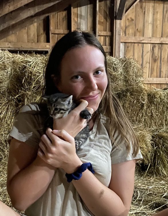 Kristen and a kitten in the barn at the Hilltop Farm in Accord NY