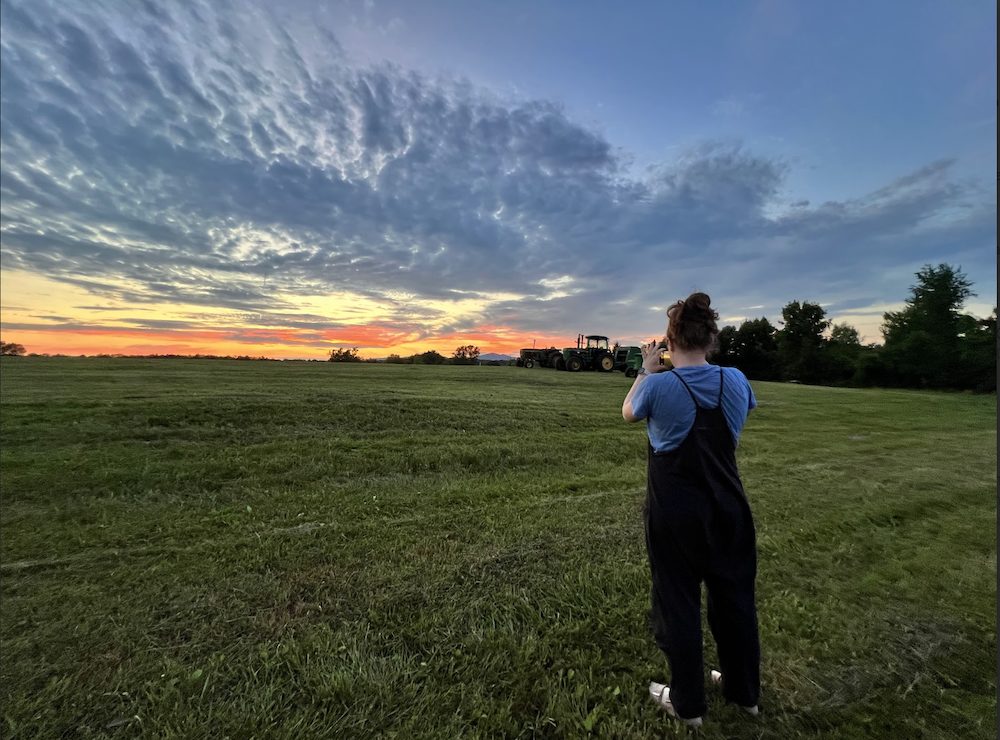 Charolette taking sunset photos of the farm at the Hilltop Farm in Accord NY