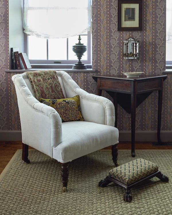 Antique white accent chair and table in primary bedroom of the 2025 Kingston Design Showhouse. Bedroom designed by Susan Brinson of House of Brinson Interior Design in New York's Hudson Valley.
