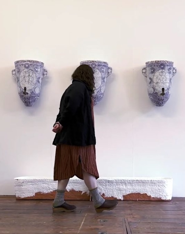 Artist Nicki Green in her studio with artwork