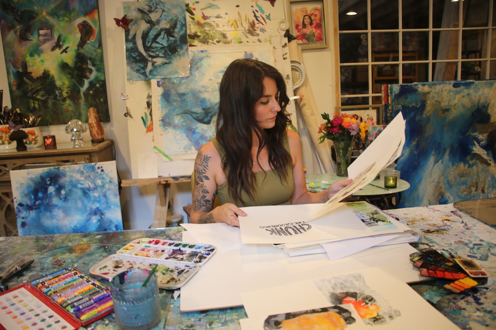working on her book in her art studio by Artist Tara Bach in Saugerties NY