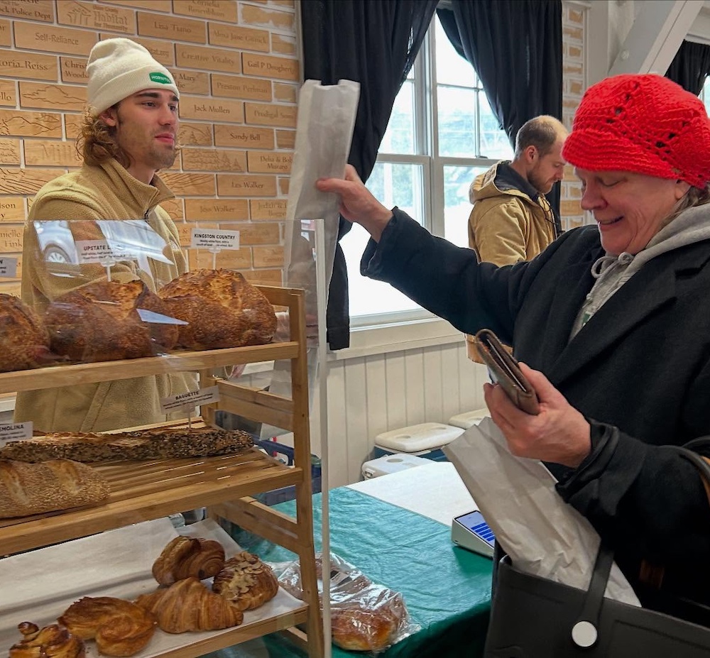 customer buying bread at the Woodstock Farmers Market