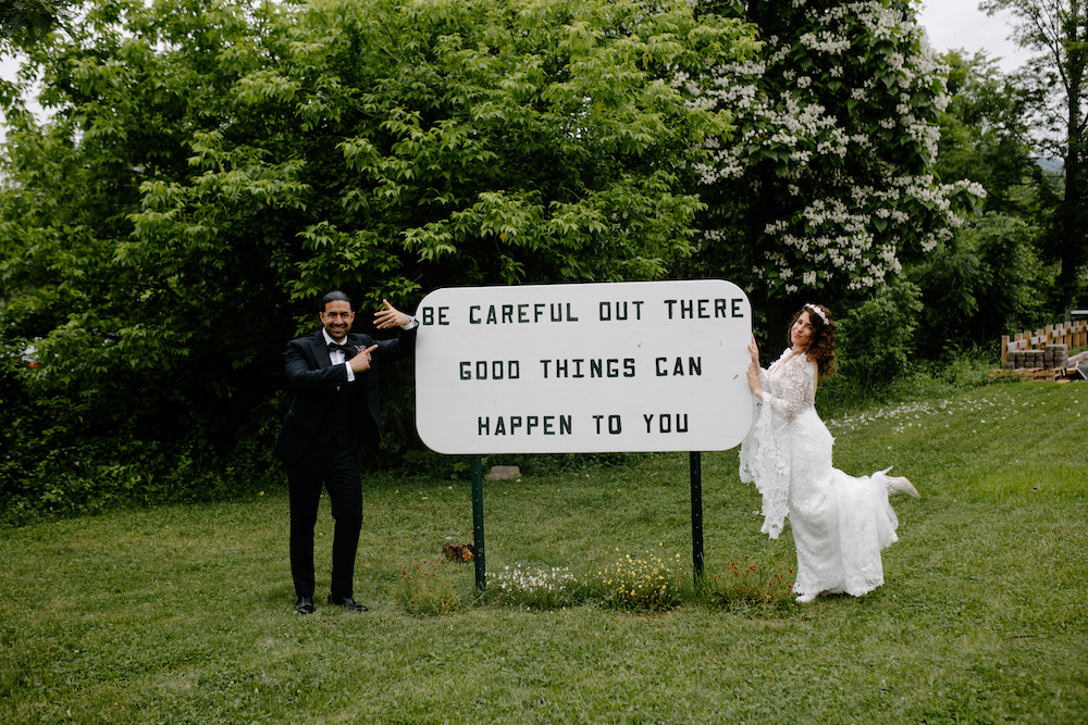 Michael Pizzano and Sarah Seeds by sign on their wedding day. The Colony Woodstock, NY.