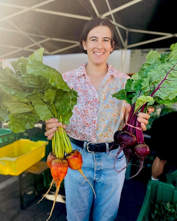 farmer holding red and golden beets