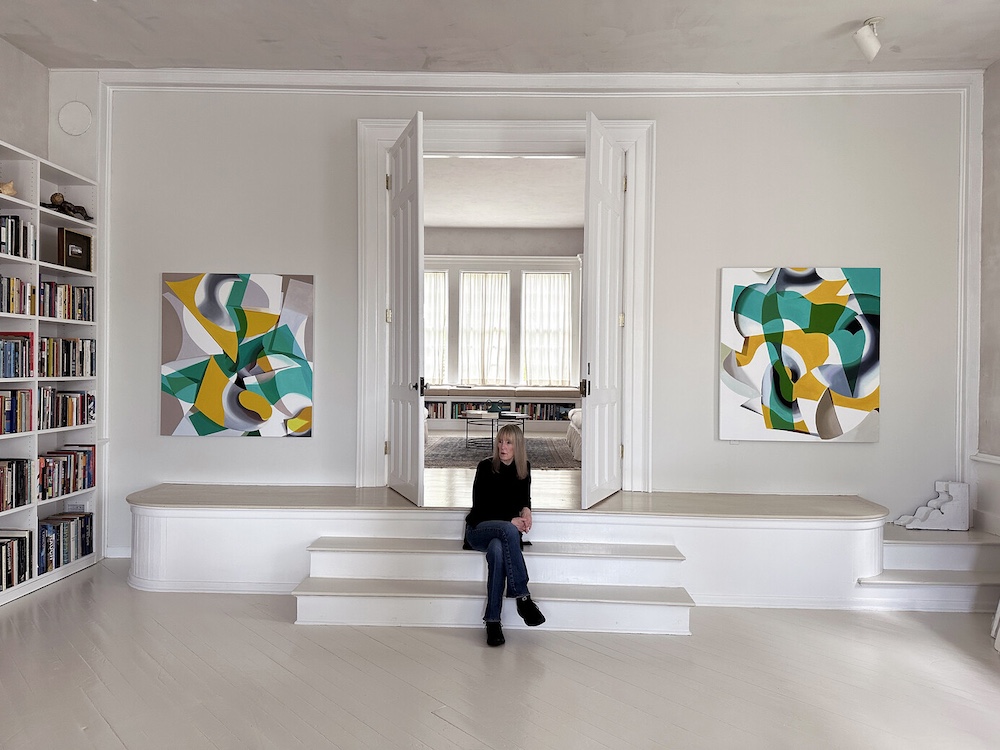 In the Studio With Ginnie Gardiner sitting on the steps in her studio