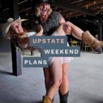 two women who are line dancing with cowboy boots and hats with the "Upstate Weekend Plans" text written across the Hudson Valley, NY photo.