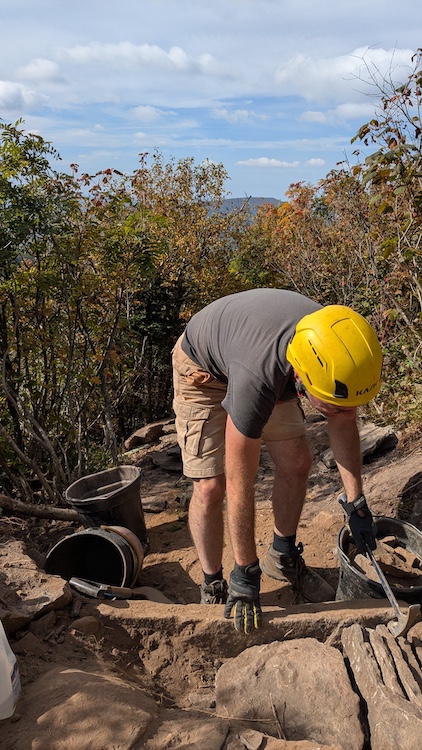 Paul Willis working on a hiking trail up on the side of a mountain in the Catskills NY