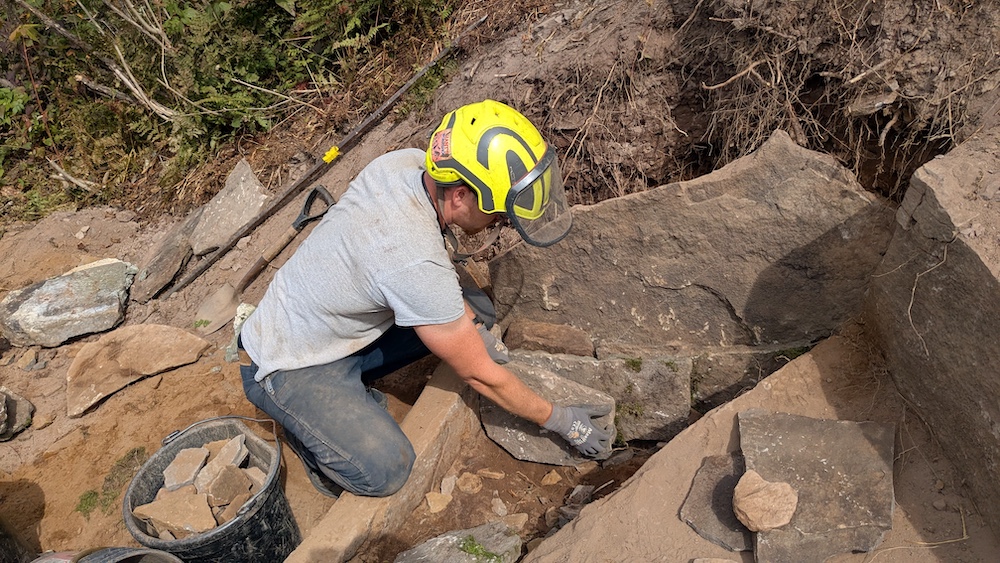 Seamus Barry working on a hiking trail up on the side of a mountain in the Catskills NY