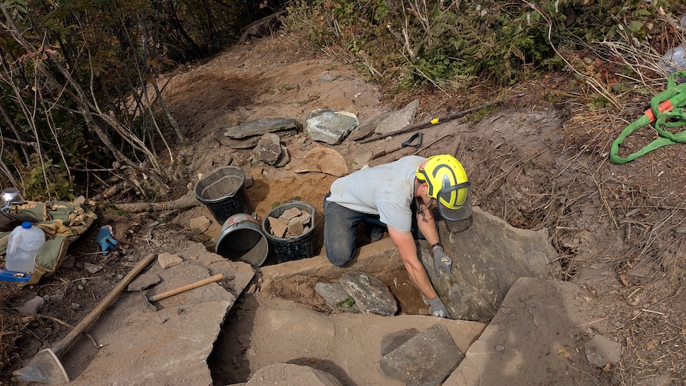 Seamus Barry working on a hiking trail up on the side of a mountain in the Catskills NY
