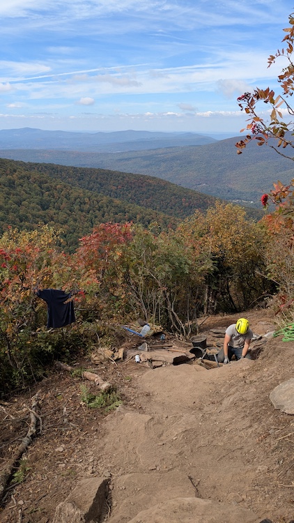 Seamus Barry working on a hiking trail up on the side of a mountain in the Catskills NY