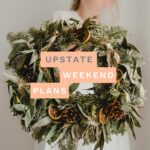 woman holding a wreath with the "Upstate Weekend Plans" text written across the Hudson Valley, NY photo.