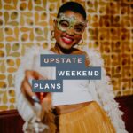 woman holding a flute with New Year's glasses on with the "Upstate Weekend Plans" text written across the Hudson Valley, NY photo.