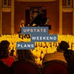piano player with candles all around her on stage with the "Upstate Weekend Plans" text written across the Hudson Valley, NY photo.