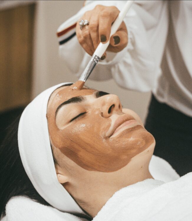woman receiving a facial at the Buttermilk Inn + Spa
