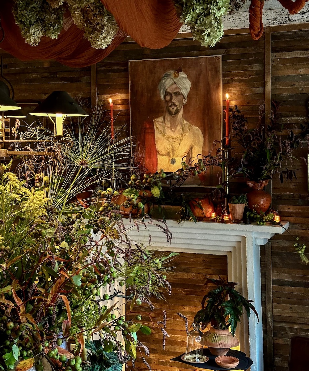 beautiful art surrounded by pottery and adornment of plants and candles at Hort & Pott in Freehold NY