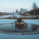 a sauna on a platform in the middle of a lake in winter