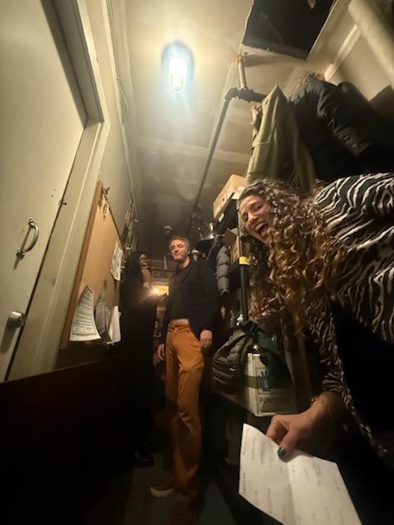 paul and a women waiting in the back laughing