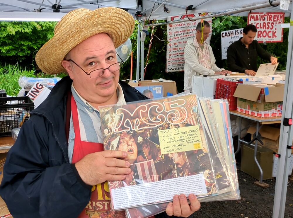 Mark Zip of Zip’s Ziggurat NY Records Fair holding up vinyl