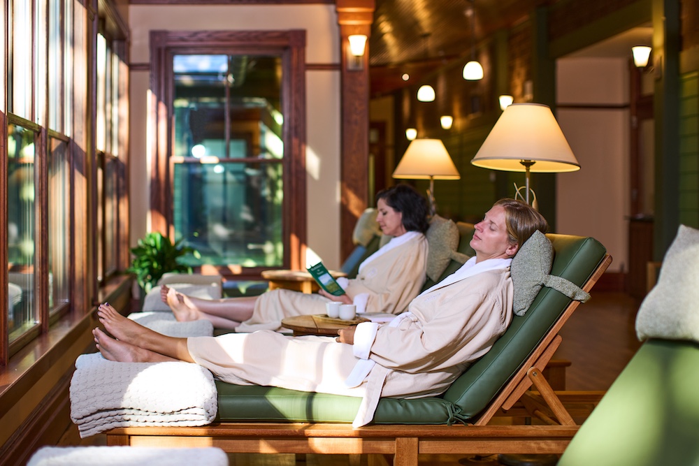 Women lounging on chairs at a spa in robes