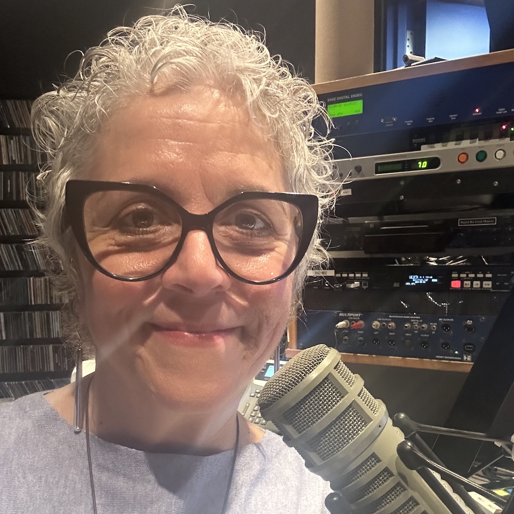 Rita Ryan smiling as a DJ Host at WVKR-FM