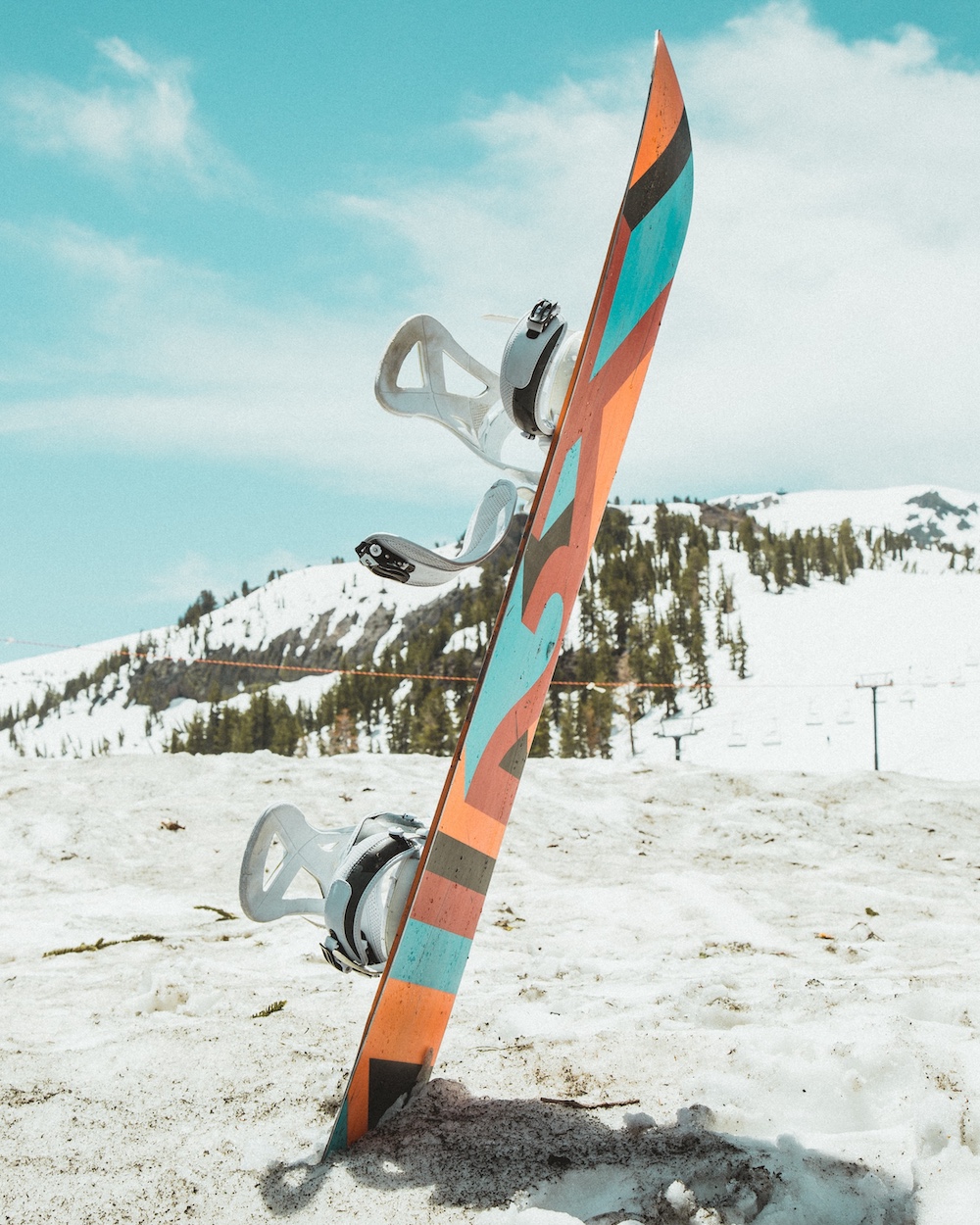 a colorful snowboard on a wintery ski slope